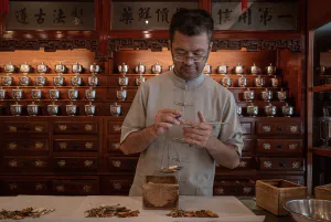 Man preparing Chinese medicine