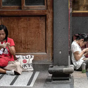 Women sitting in the precinct of Lungshan Temple