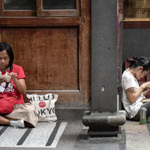 Women sitting in the precinct of Lungshan Temple