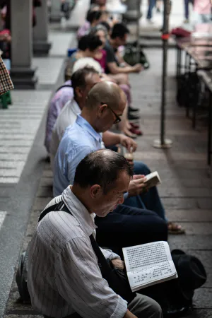 Men reciting sutra while sitting in Lungshan Temple
