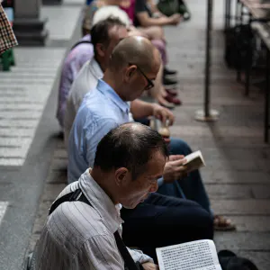 Men reciting sutra while sitting in Lungshan Temple