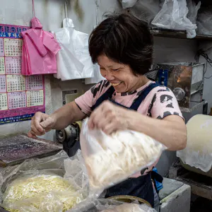 Bashful clerk working in a noodle making shop