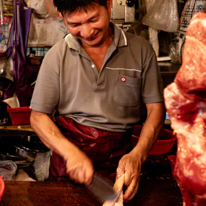 Butcher cutting happily