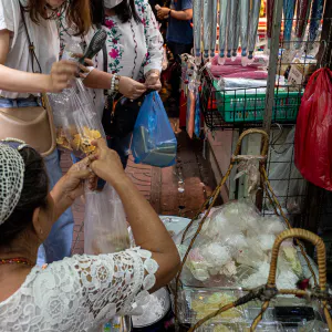 Street vendor and customers in Sampeng Market