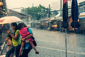 Family walking in heavy rain