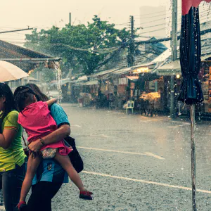 Family walking in heavy rain