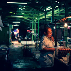 クロントゥーイ市場の薄暗い通路に立つ男