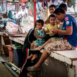 Family relaxing in Khlong Toei Market