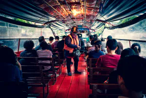 Conductor collecting money on a water bus