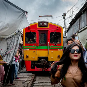 Tourists excited about the train in Maeklong Railway Market