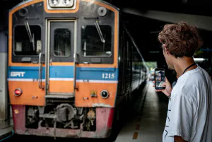 Man making a video of Maeklong Railway