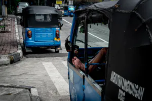 Blue three-wheeled taxi called Bajaj in Jakarta