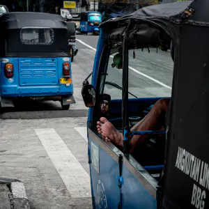 Blue three-wheeled taxi called Bajaj in Jakarta