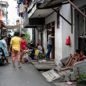 People hanging out in the narrow lane in the residential area