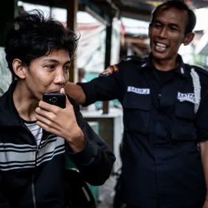 Two men standing talking in the residential area in Jakarta