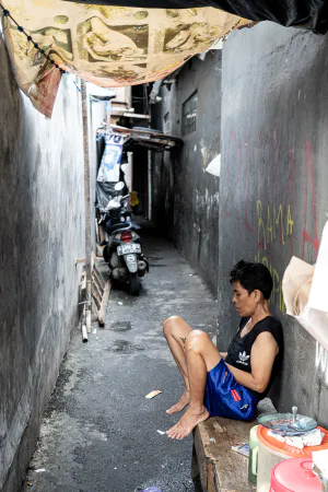 Shopkeeper resting in the lane in Jakarta