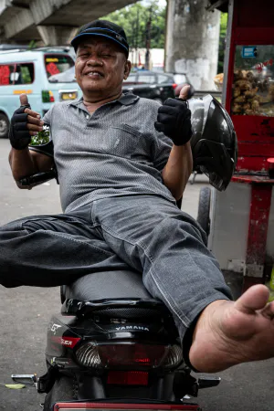 Motorbike taxi driver giving a happy thumbs up