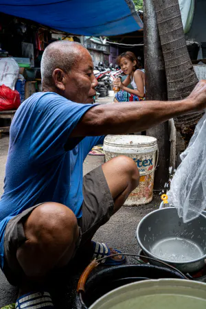 Old man washing up buckets