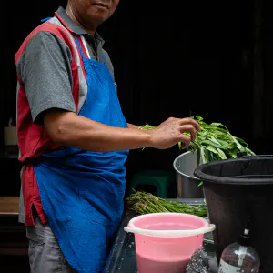 Man washing vegetables with detergent