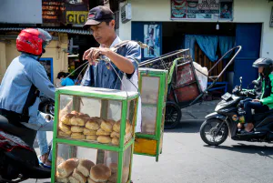 Young man peddling breads with a carrying pole