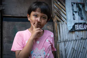 Girl making a peace sign