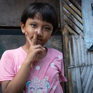 Girl making a peace sign