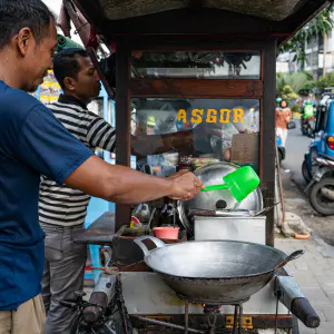 Two men working at a food stall