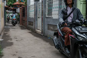 Motorbikes running through an alleyway