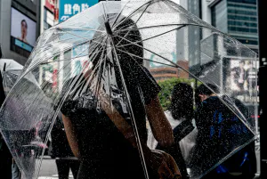 Young woman holding a plastic umbrella