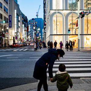Parent and child walking through Ginza