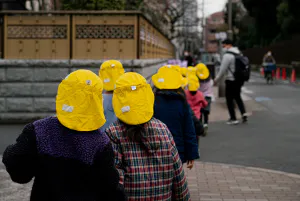 Kindergarteners in yellow caps