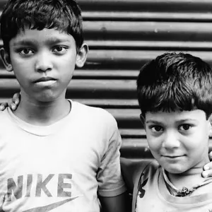 Two boys standing in front of shutter