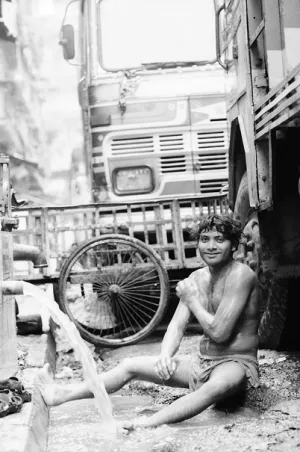 Man washing body by roadside