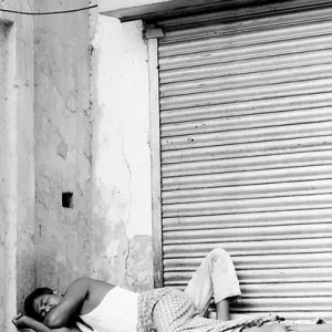 Man sleeping in front of shutter