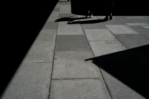 Women's legs walking between shadows
