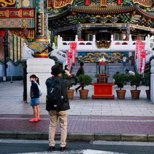 People taking pictures in front of the Mazu Temple in Yokohama