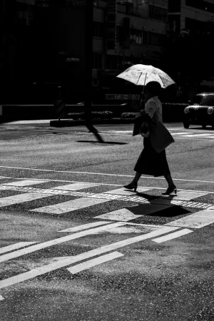 Woman with sunshade crossing