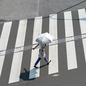 Woman walking with parasol