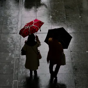 Silhouette of a couple with umbrellas