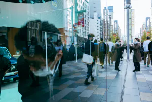 The streetscape of Ginza reflected in the glass of the NISSAN CROSSING