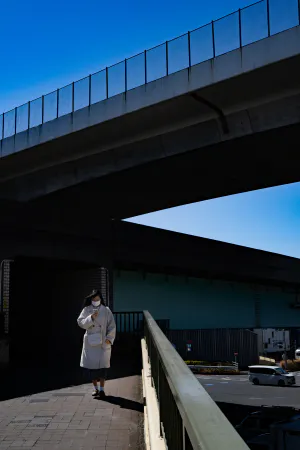 Woman walking on pedestrian bridge