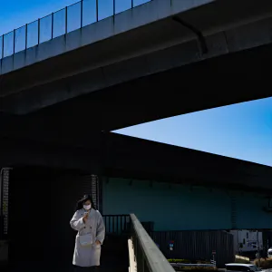 Woman walking on pedestrian bridge