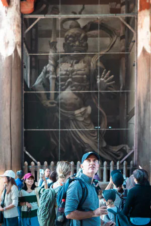 Man looking at the statue of Vajrayaksa at Nandai-mon