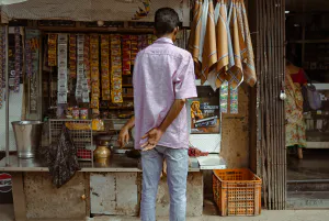 Back view of a man shopping at a kiosk