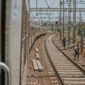 Men walking by the railroad tracks