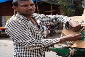 Man attaching a load to a cart