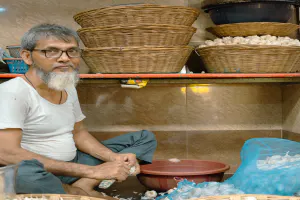 Man breaking apart garlic cloves