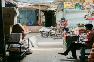 Man sitting at the entrance to the market