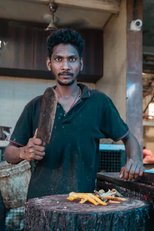 Man cutting chicken