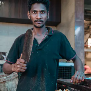 Man cutting chicken